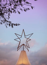 Low angle view of communications tower against sky at sunset