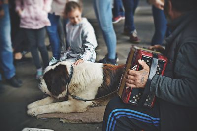 Rear view of people with dog