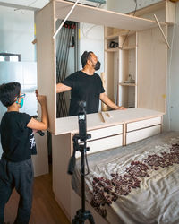 Wardrobe assembly in progress. diy at home. father and son.