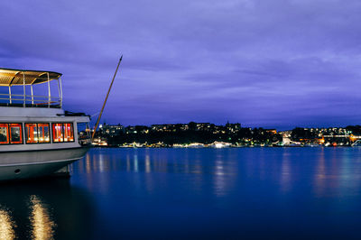 Boats in river with buildings in background
