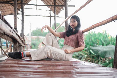 Full length of woman sitting in park