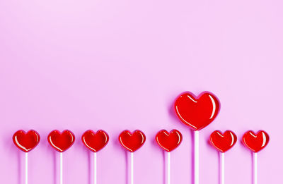 Close-up of heart shape over pink background