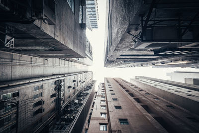 Directly below shot of buildings against sky