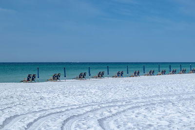 Scenic view of beach against clear blue sky