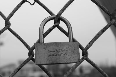 Close-up of padlocks on fence