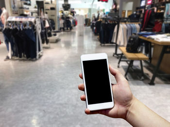 Midsection of person using mobile phone