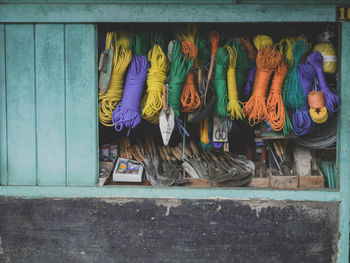 Close-up of ropes and work tool in cabinet