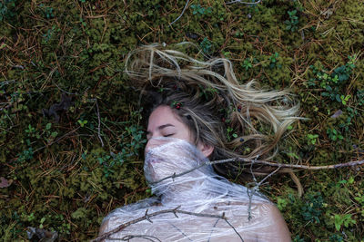 Young woman lying on grass