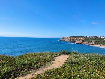 Scenic view of sea against blue sky