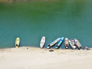 High angle view of shoes moored on beach