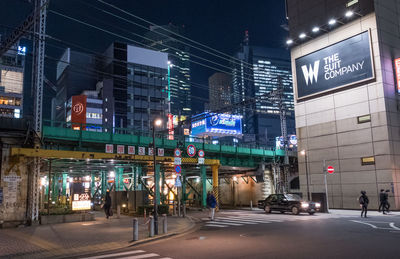 Illuminated city street and buildings at night