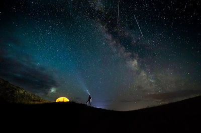 Low angle view of silhouette stars in sky at night