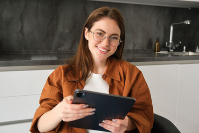 Young woman using digital tablet