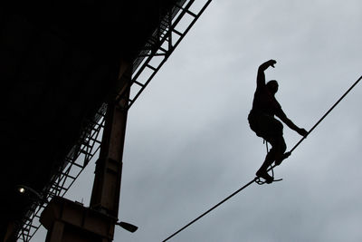 Low angle view of silhouette man against sky