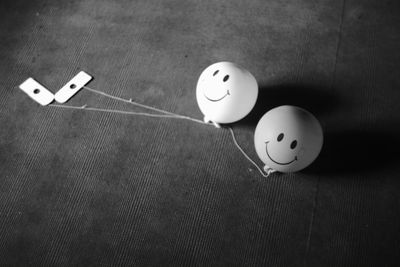 High angle view of smiley face balloons on table