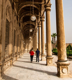 People walking in corridor of building