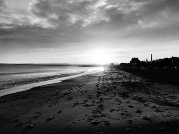 Scenic view of beach against sky during sunset