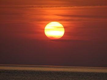 Scenic view of sea against orange sky