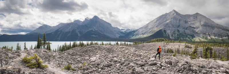 Panoramic view of man standing on mountain against sky