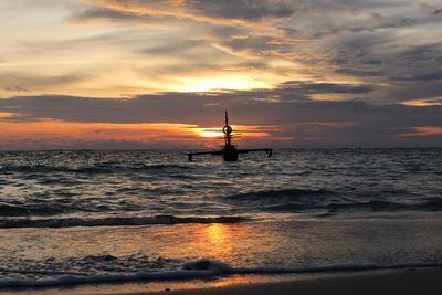 Silhouette boat on sea against sky during sunset