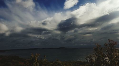 Scenic view of sea against storm clouds