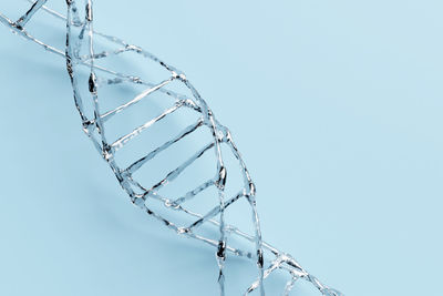 Close-up of dna over blue background