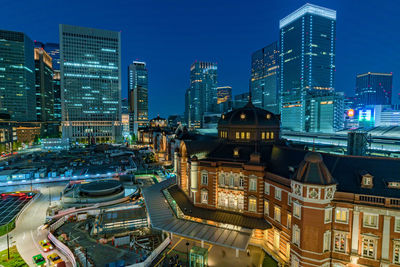 High angle view of city lit up at night