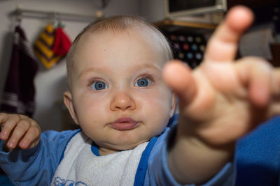 Close-up portrait of cute girl drooling at home