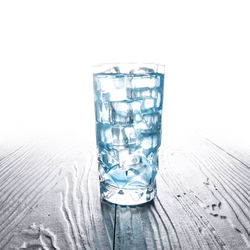 Close-up of wine glass on table against white background