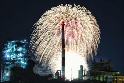 Firework display over city at night