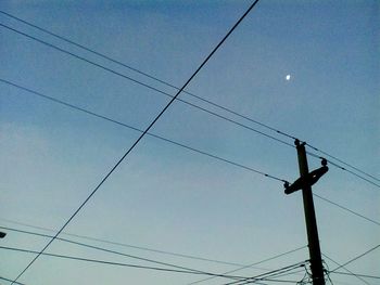 Low angle view of electricity pylon against sky