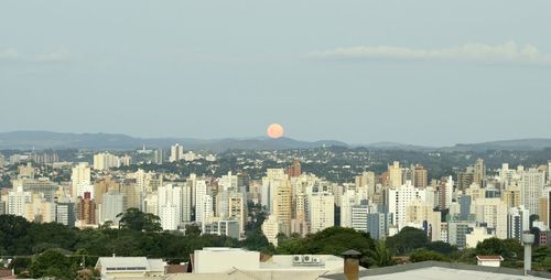 Buildings in city against cloudy sky