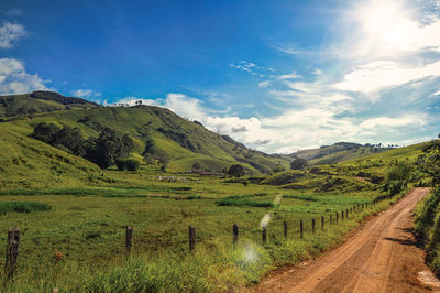 View of rural road next to green hills near the town of joanopolis. brazil. 