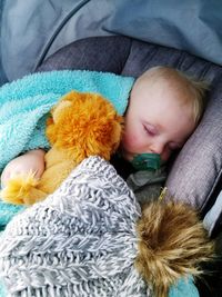 Close-up of cute baby sleeping on bed