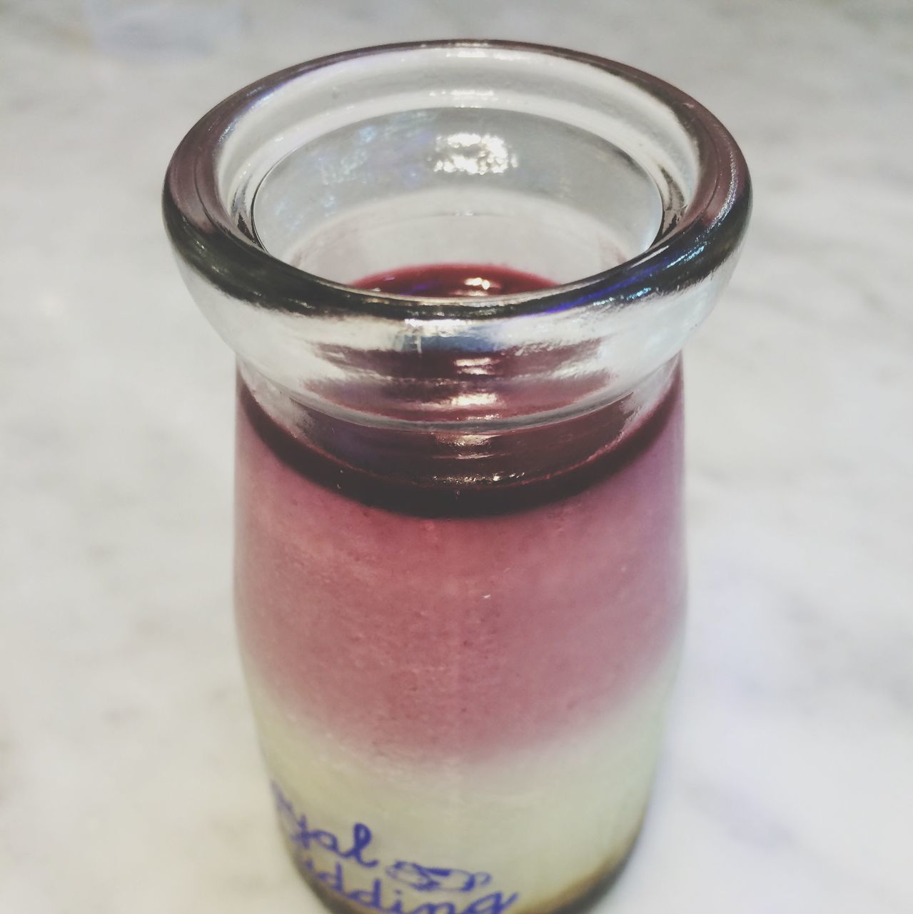 food and drink, freshness, drink, refreshment, close-up, drinking glass, glass - material, still life, transparent, indoors, glass, cold temperature, table, focus on foreground, pink color, ice, selective focus, no people, high angle view, ice cube