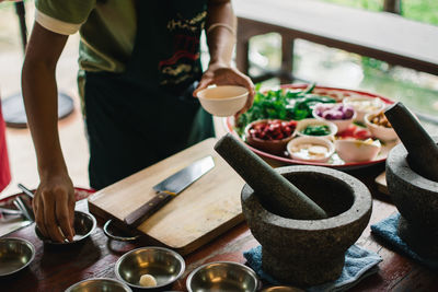 Midsection of man preparing food on table