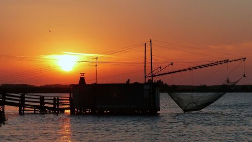 Scenic view of sea against orange sky during sunset