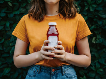 Midsection of woman using mobile phone