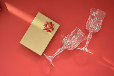 High angle view of gift box on red background