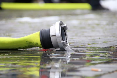 Close-up of water bottle on lake