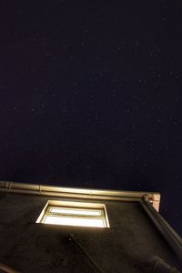 Low angle view of illuminated building against sky at night