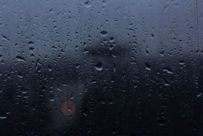 Full frame shot of raindrops on glass window