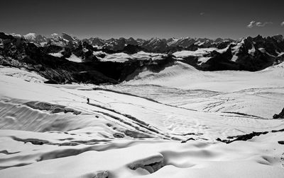 Scenic view of snow covered mountains against sky