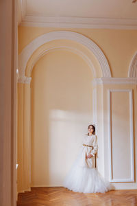 Portrait of bride standing in corridor
