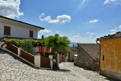 A narrow street among the old houses of greci, a village in the campania region, italy.