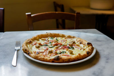 Close-up of pizza served on table