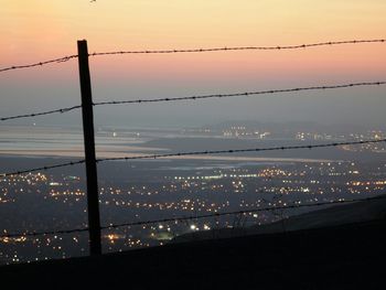 Power lines against sky at dusk