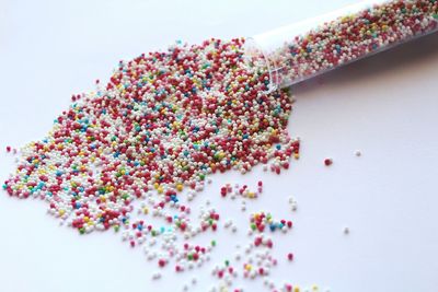 Close-up of multi colored candies against white background