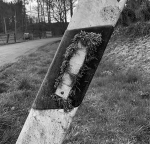 Close-up of old rusty hanging on field