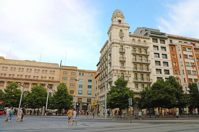 Group of people in front of building against sky